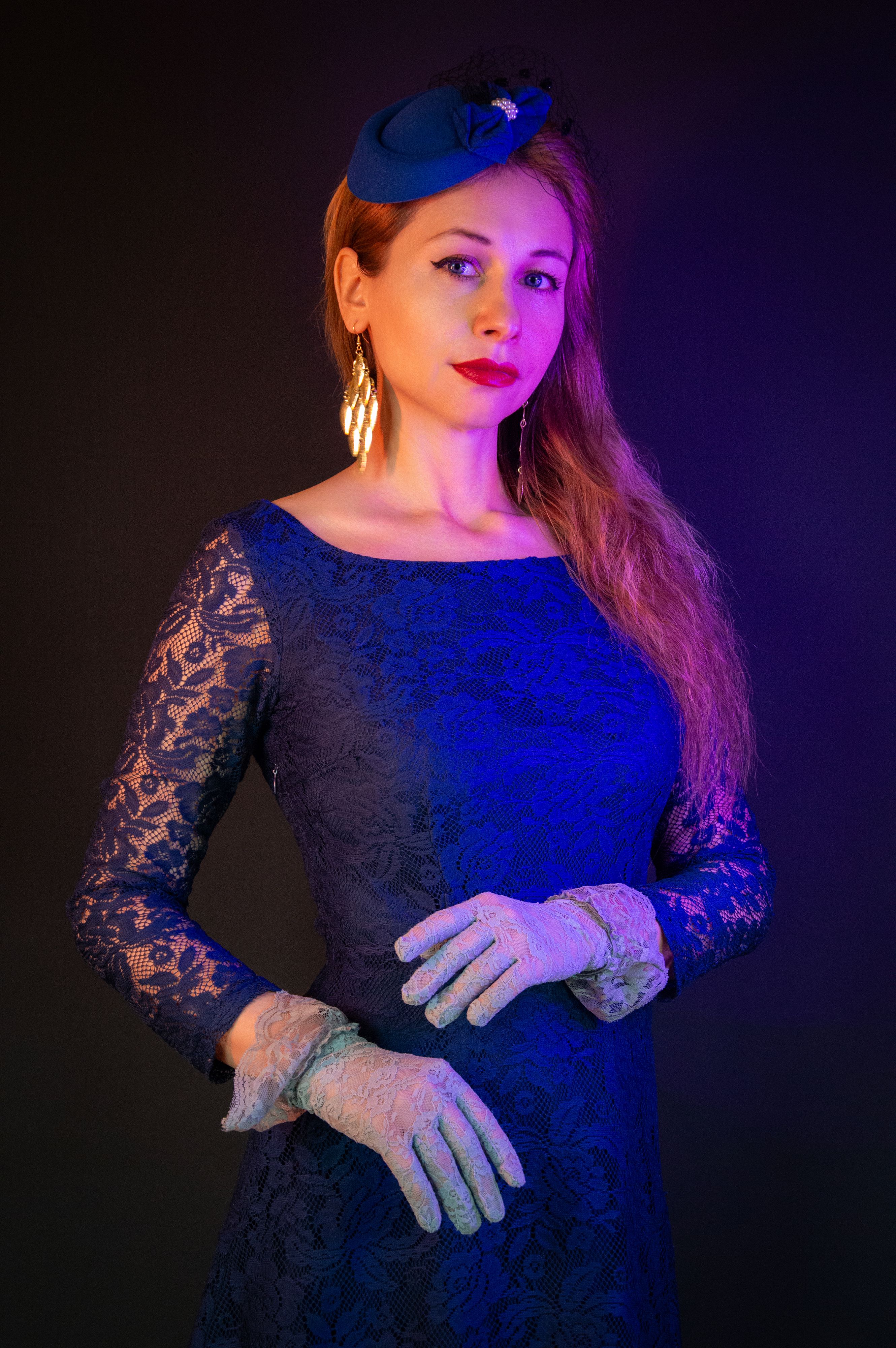 Elegant woman in vintage blue dress and gloves, evoking a historic courtesan's refined style